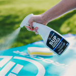 Person spaying the iROCKER SUP Cleaner & Protectant to their board | Lifestyle