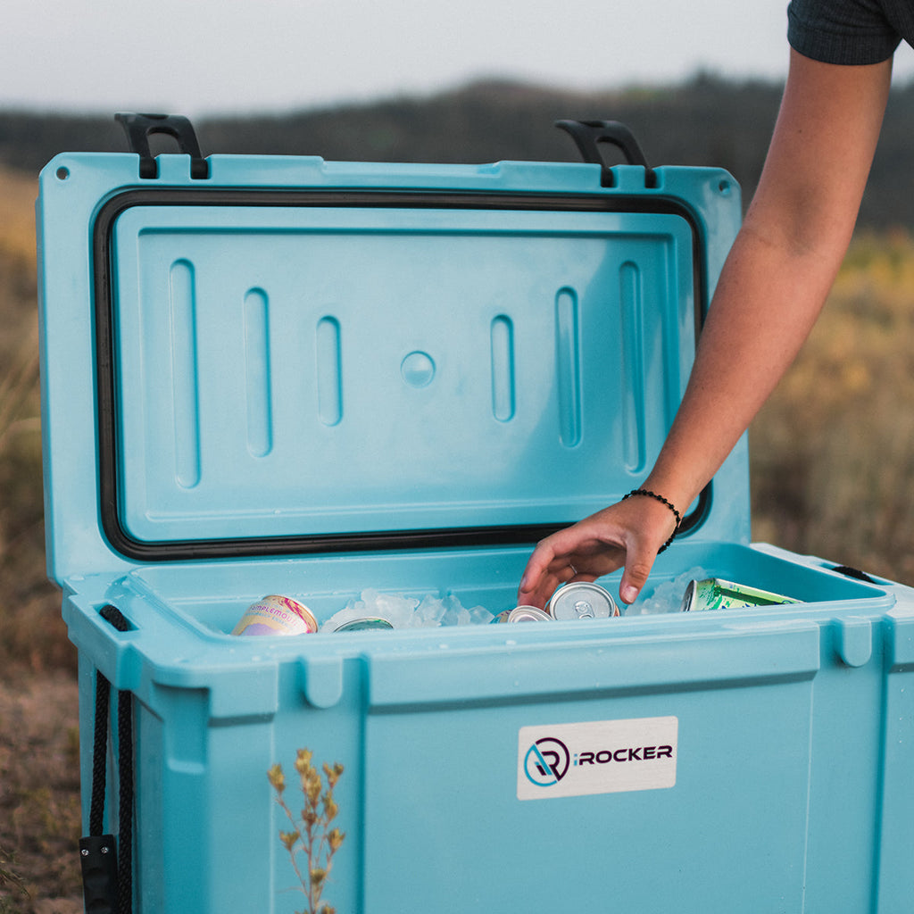 Person grabbing a drink from the Irocker hard cooler