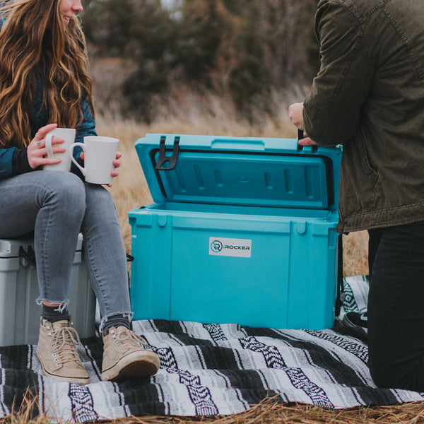 Person grabbing a drink from the Irocker hard cooler  Gray